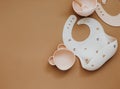 Cute baby bib for food on brown light background, Royalty Free Stock Photo