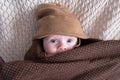 Cute baby with big blue eyes wearing a hat and a huge knitted scarf Royalty Free Stock Photo