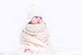 Cute baby in a big knitted scarf and hat Royalty Free Stock Photo