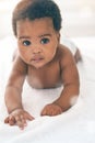 Cute baby, black kids and portrait of crawling on bed for play, fun and relax in nursery room. Young african infant Royalty Free Stock Photo