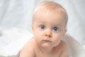 Cute baby with blue eyes lying on bed Royalty Free Stock Photo