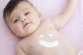 Cute baby with body cream on tummy Royalty Free Stock Photo