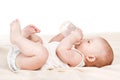 Cute baby with a bottle of milk on a beige blanket Royalty Free Stock Photo