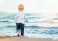 Cute baby boy on the beach, admiring the sea. Bare feet. Happy Royalty Free Stock Photo