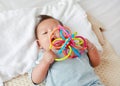 Cute baby boy biting colorful bites toy Royalty Free Stock Photo