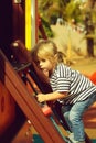 Cute baby boy climbing rope net or ladder Royalty Free Stock Photo