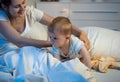 Cute baby boy crawling on bed at night Royalty Free Stock Photo