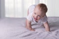 Cute baby boy doing first steps. Lovely infant kid begining to toddle. Royalty Free Stock Photo