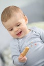 Cute baby boy eating a biscuit Royalty Free Stock Photo