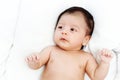 The cute baby boy is happy relax closeup on the white bed Royalty Free Stock Photo