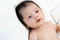 The cute baby boy is happy relax closeup on the white bed Royalty Free Stock Photo