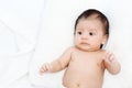 The cute baby boy is happy relax closeup on the white bed Royalty Free Stock Photo