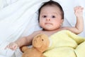 The cute baby boy is happy with yellow blanket and doll bear Royalty Free Stock Photo