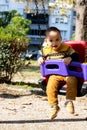 Cute baby boy having fun on outdoor playground. Toddler activities. Happy baby swinging on the swing Royalty Free Stock Photo