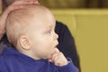 Cute baby boy holding his fingers in his mouth. His face has a thoughtful look. Royalty Free Stock Photo