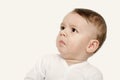 Cute baby boy looking up upset. Royalty Free Stock Photo