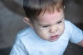 Cute baby boy looking in the window glass with reflection. Loneliness of children. Orphanage and orphans Royalty Free Stock Photo