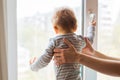 Cute baby boy looks in the window Royalty Free Stock Photo