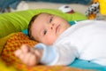 Cute baby boy is lying on colourful carpet Royalty Free Stock Photo