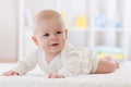 Cute baby boy lying on belly in nursery room Royalty Free Stock Photo