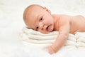 Cute baby boy lying on stack of towels Royalty Free Stock Photo