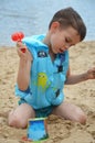 Cute baby boy playing with beach toys Royalty Free Stock Photo