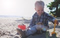 Cute baby boy playing with beach toys on tropical beach Royalty Free Stock Photo