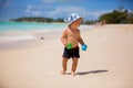 Cute baby boy playing with beach toys on tropical beach Royalty Free Stock Photo