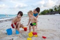 Cute baby boy playing with beach toys on tropical beach Royalty Free Stock Photo