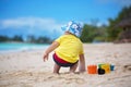 Cute baby boy playing with beach toys on tropical beach Royalty Free Stock Photo