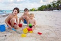 Cute baby boy playing with beach toys on tropical beach Royalty Free Stock Photo