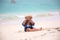 Cute baby boy playing with beach toys on tropical beach Royalty Free Stock Photo