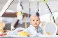 Cute baby boy playing with hanging toys arch on mat at home Baby activity and play center for early infant development