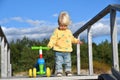 Cute baby boy playing with his colorful balance bike