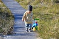 Cute baby boy playing with his colorful balance bike