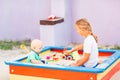 Cute baby boy playing with his sister in the sandbox Royalty Free Stock Photo