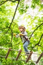 Cute baby boy playing. Kid climbing trees in park. Hike and kids concept. Beautiful little child climbing and having fun Royalty Free Stock Photo