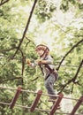 Cute baby boy playing. Kid climbing trees in park. Hike and kids concept. Beautiful little child climbing and having fun Royalty Free Stock Photo