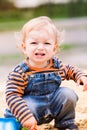 Cute baby boy playing with sand Royalty Free Stock Photo