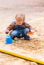 Cute baby boy playing with sand Royalty Free Stock Photo