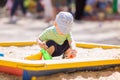 Cute baby boy playing with sand Royalty Free Stock Photo