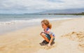 Cute baby boy playing with sand on summer tropical beach. Royalty Free Stock Photo