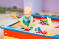 Cute baby boy playing in the sandbox Royalty Free Stock Photo