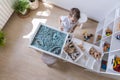 Cute baby boy playing sensory box kinetic sand table with farm animals