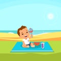 Cute baby boy sitting at the beach with blanket under him Royalty Free Stock Photo