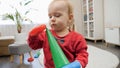 Cute baby boy smiling after assembling colorful toy tower. Baby development, child playing games, education and learning Royalty Free Stock Photo