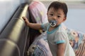 Cute baby boy with sucking pacifier lying on bed Royalty Free Stock Photo