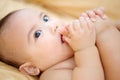 Cute Baby Boy sucking thumb on the bed Royalty Free Stock Photo