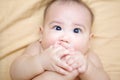 Cute Baby Boy sucking thumb on the bed Royalty Free Stock Photo