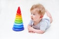 Cute baby boy with toy pyramid on light background Royalty Free Stock Photo